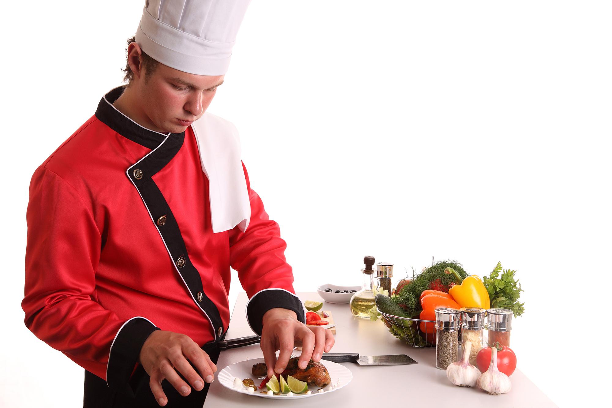 Instructor demonstrating a plated dish in a warm kitchen